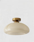 Plafonnier en verre jaune laitonné design, forme arrondie, idéal pour éclairage moderne du salon ou de la chambre.