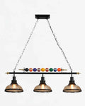 Suspension style billard industriel avec trois lampes en verre, luminaire vintage idéal pour bar, restaurant ou salle à manger.
